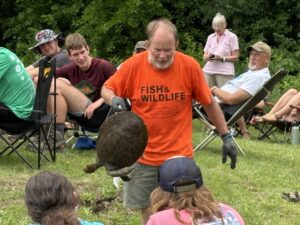 Denny Weiss handles a softshell turtle for a Project AWARE nature program.