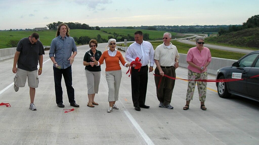 A very small ribbon-cutting ceremony was held for the U.S. Highway 30 Tama-Toledo bypass at the west end of that bypass August 13, 2011, in Toledo, Iowa. The four-lane road is the fourth alignment of the highway here since 1926. Photo by author.